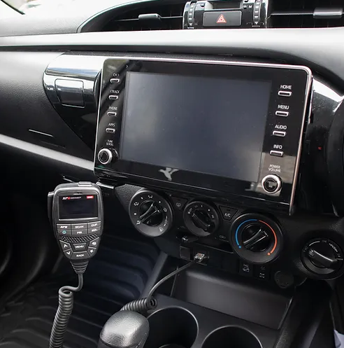 UHF Handpiece Mounted on A Holder Beside a Car Display