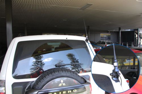 Rear view of a car with an antenna installed with boot mount