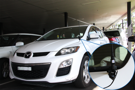 Car standing in the garage with an antenna installed with RFI bonnet mount