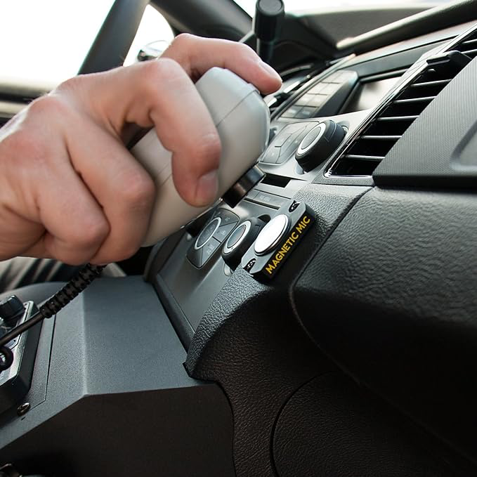 Person mounting a handpiece on a magnetic mic holder 