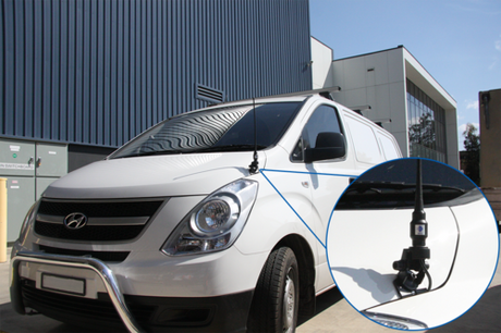 Front view of a car with an antenna installed with RFI bonnet mount